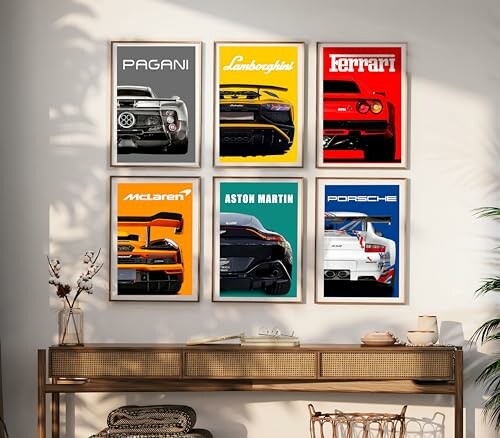 Wall with framed posters of car brands Pagani, Lamborghini, Ferrari, McLaren, Aston Martin, and Porsche.